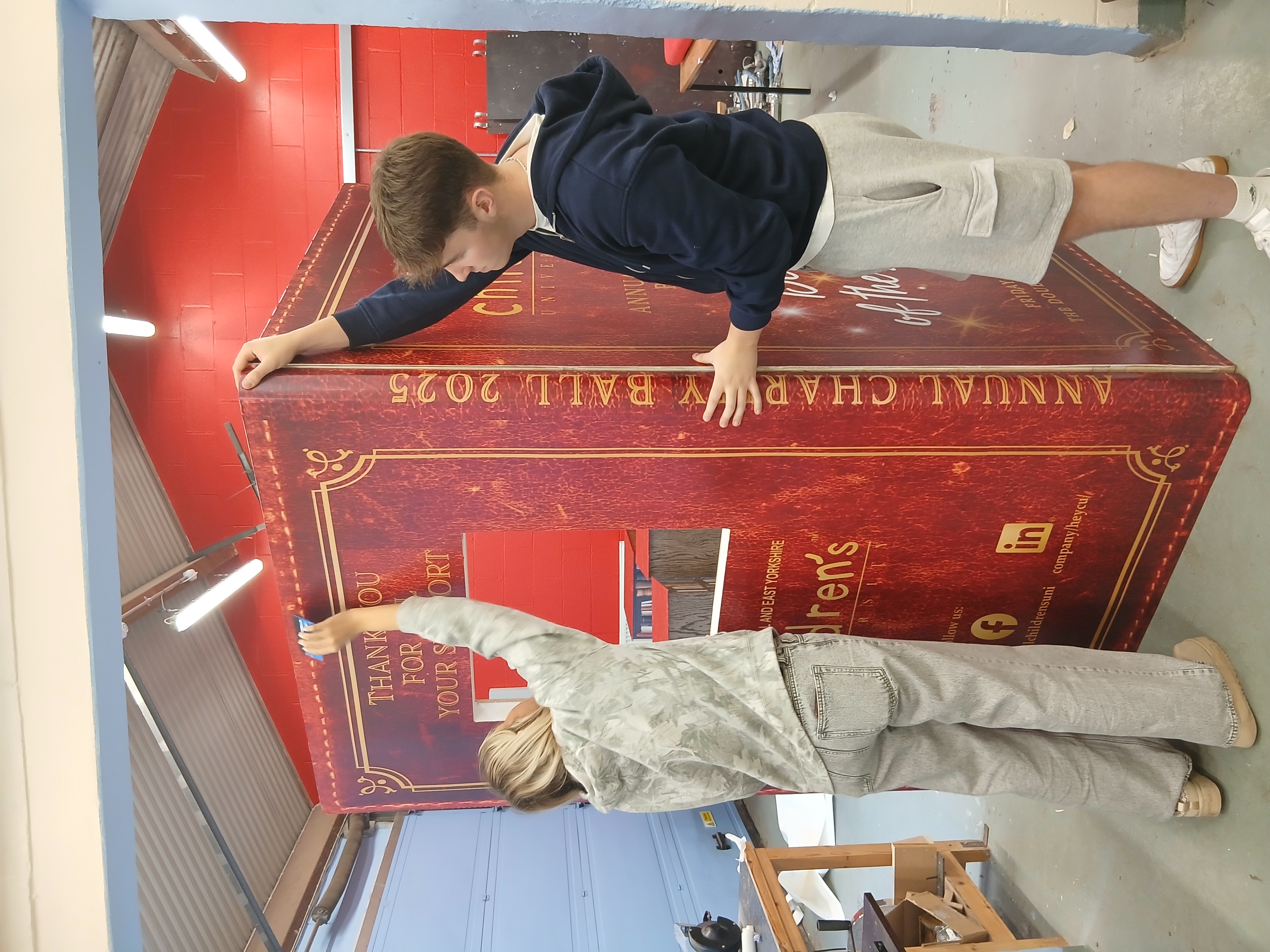 Hull Children’s University Charity Ball 2025, DoubleTree Hilton Hull, book-themed props created by our Signmaking, Joinery, and Carpentry apprentices in collaboration with Hobson & Porter