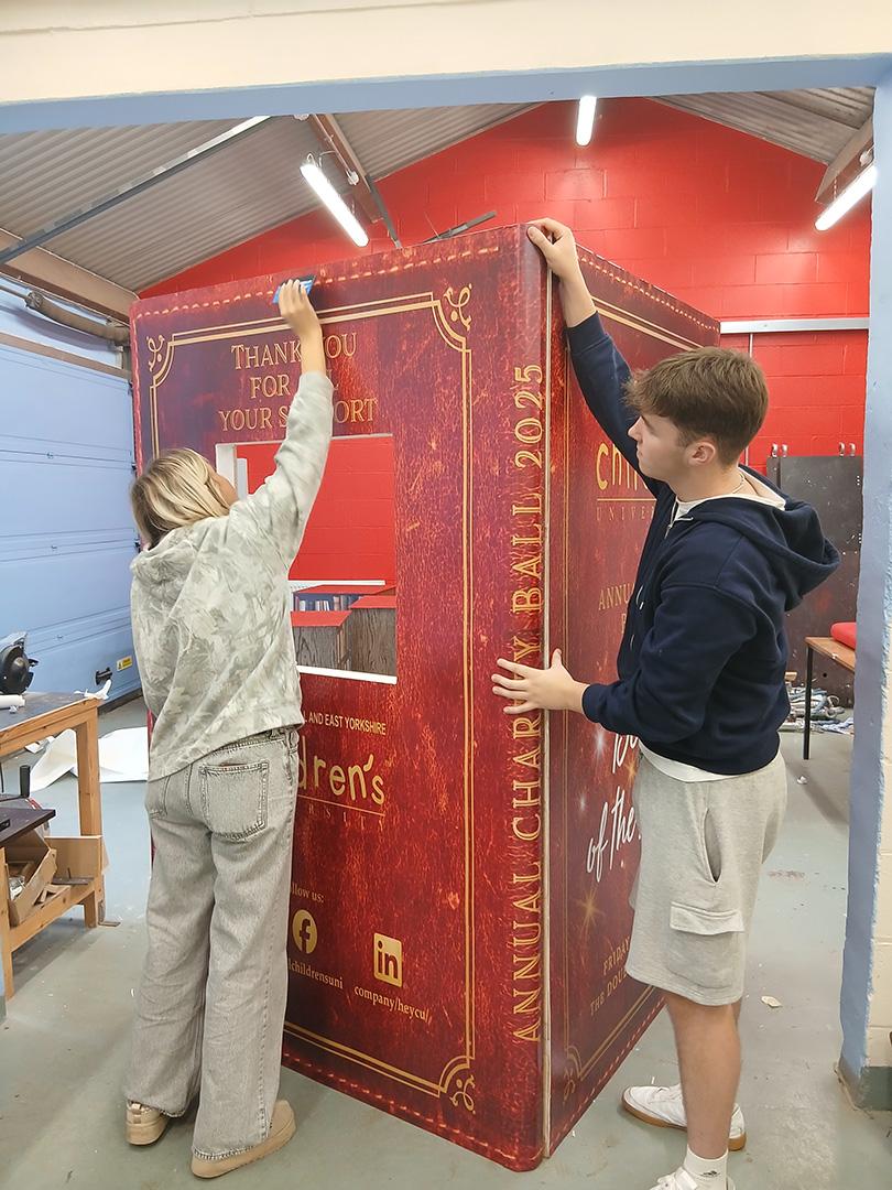 Hull Children’s University Charity Ball 2025, DoubleTree Hilton Hull, book-themed props created by our Signmaking, Joinery, and Carpentry apprentices in collaboration with Hobson & Porter