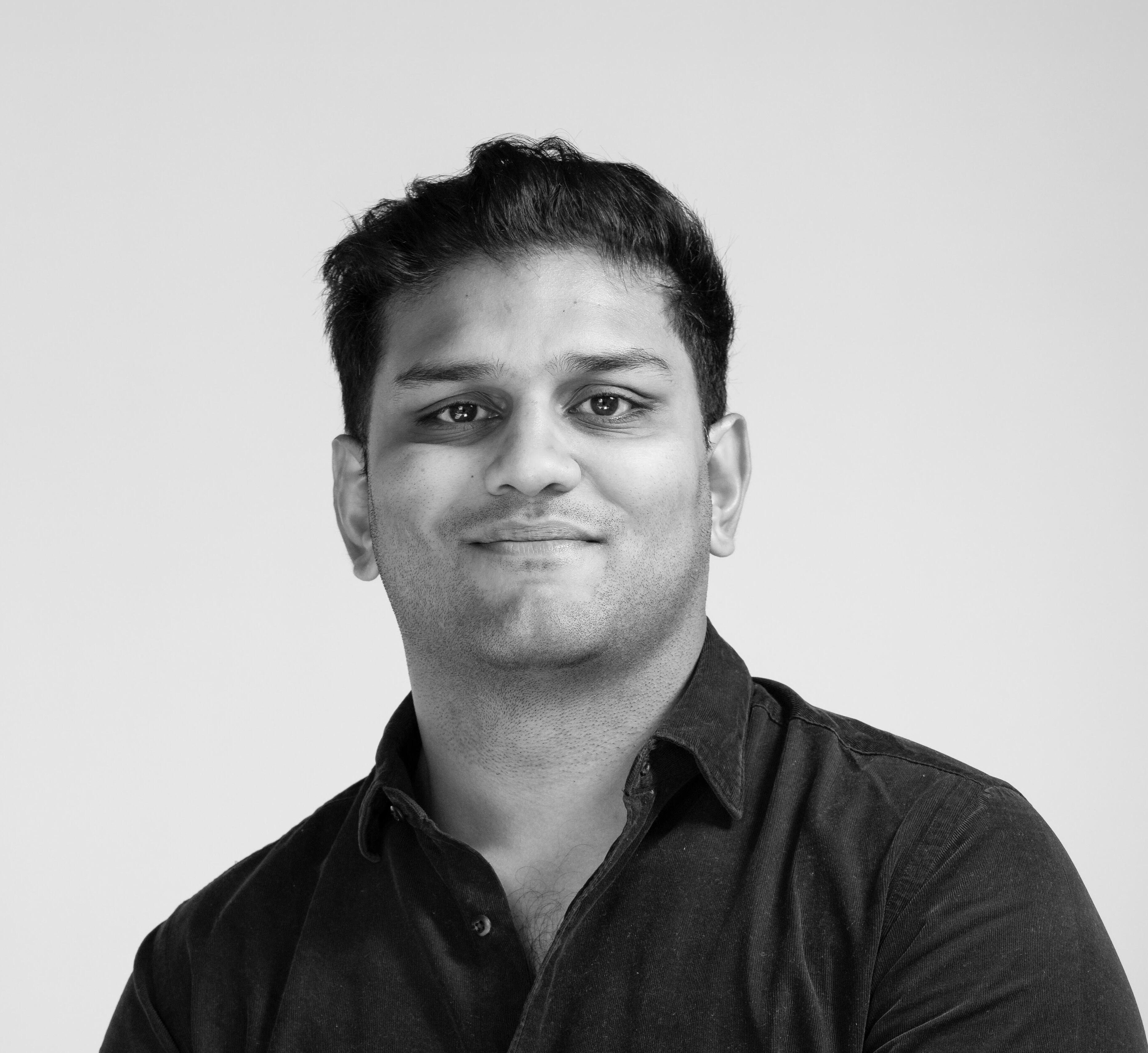 A black and white photograph of Malin Patel, the CEO of Enterprise4All