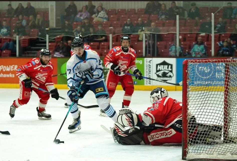 A photograph of Ethan playing ice hockey