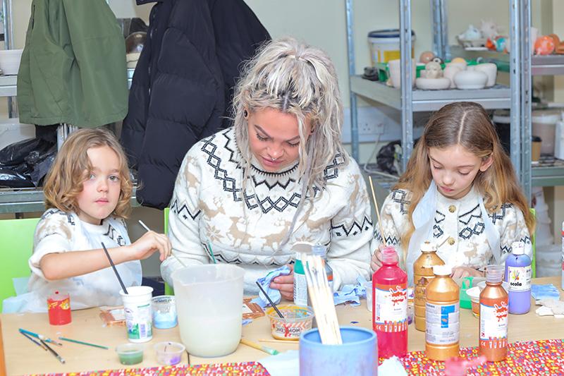 Two children and an adult doing crafts