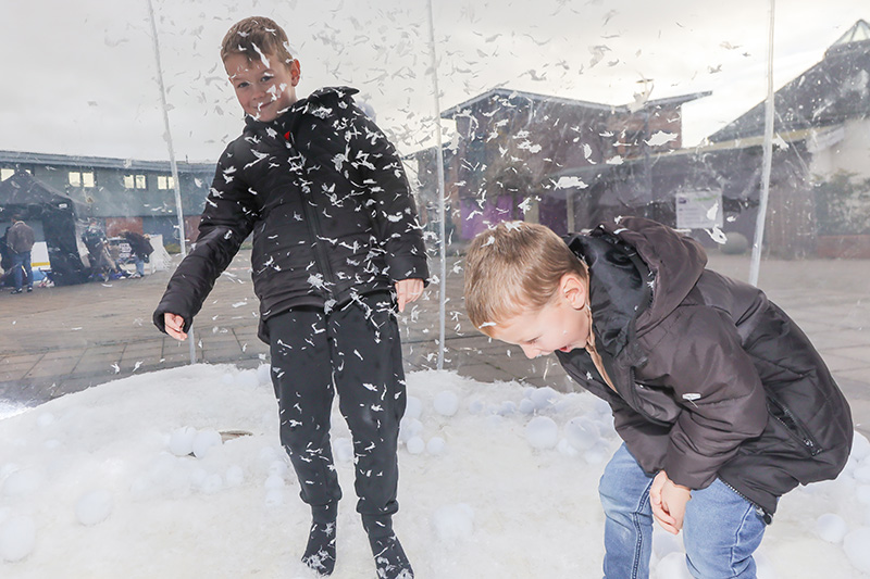 Two children in a large snow globe