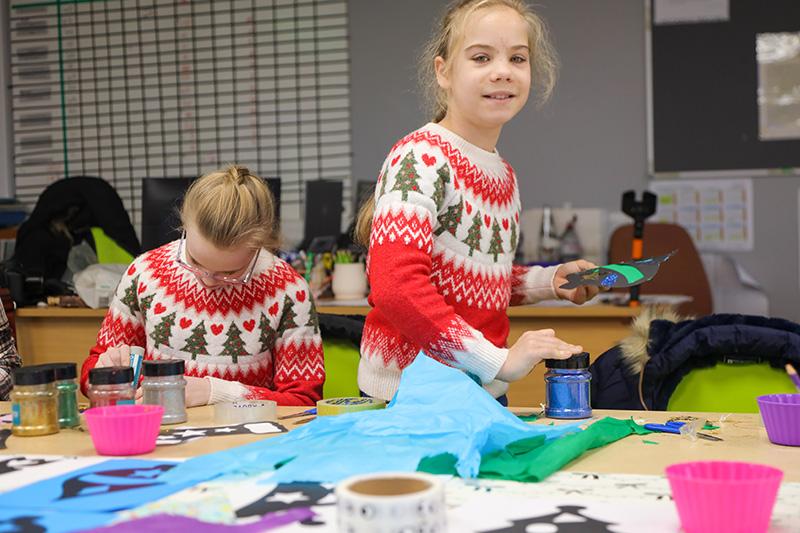 Two children doing crafts