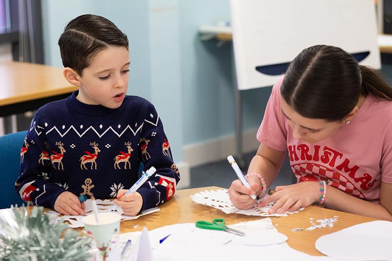 Two children doing crafts