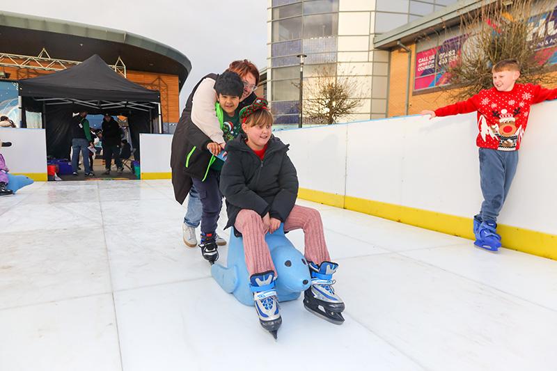 A child being push on a seal themed sled