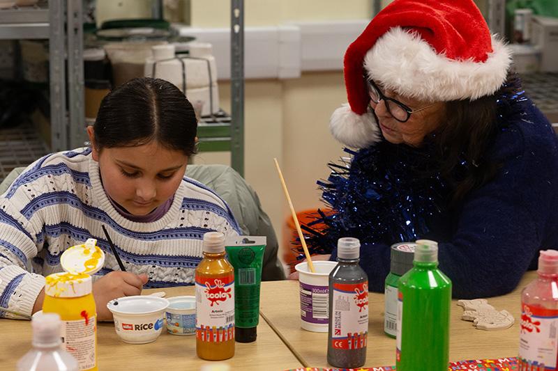 Cllr Tock and a child doing crafts