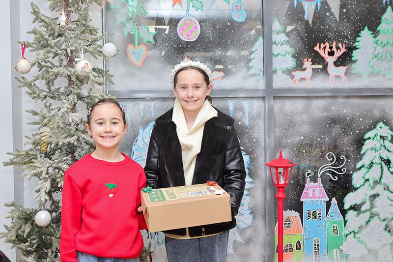 Two children in front of Narnia window art